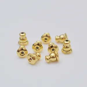 Macro detail of 14k gold-filled bullet earring backs with silicone inserts for DIY studs