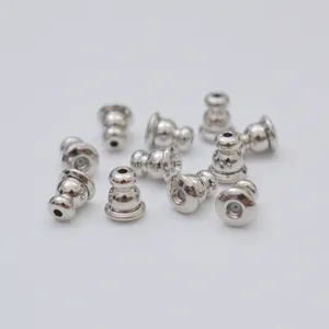 Macro shot of silver metal ear stud backings with silicone inserts for DIY jewelry