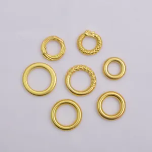 Set of six handcrafted gold-plated rings including twisted rope and Ouroboros designs