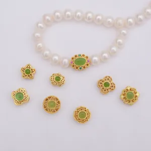 Antique gold clover and butterfly beads on pearl necklace with green gemstones