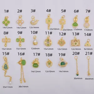 Assorted gold-plated charms with jade, pearls, and clover or rabbit designs