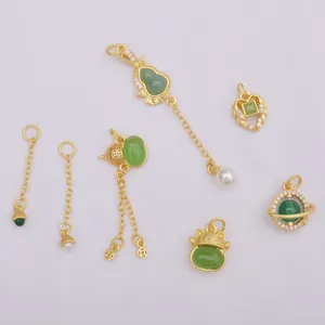 Collection of ancient gold style pendants with green jade and lucky cat charms