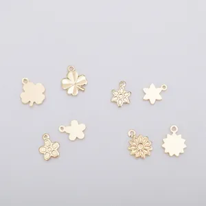 Detailed view of 14k gold-filled clover and daisy charms for DIY jewelry making