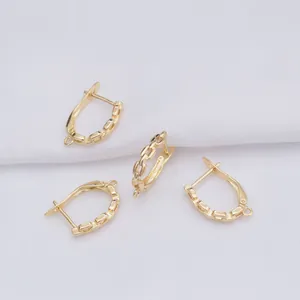 Macro view of 14k gold-filled U-shape earring hooks with chain texture and hanging loops