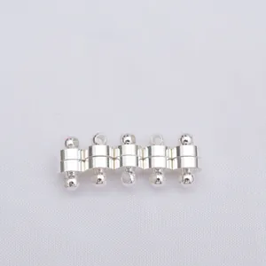 Macro detail of five silver cylindrical magnetic clasps for DIY jewelry making