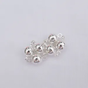 Close-up of five silver magnetic ball clasps with rings for DIY necklace making