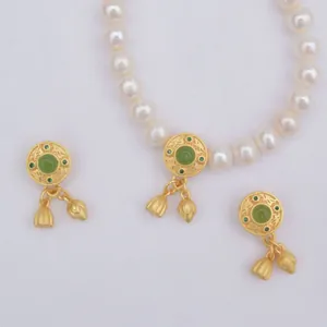 Elegant sand gold pearl jewelry set with green stones and lotus charms in classic style