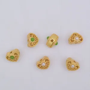 Hollow heart-shaped gold beads set with green gemstones and white pearls for DIY jewelry