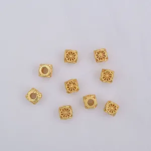 Detailed view of nine gold hollow floral square beads for DIY jewelry making