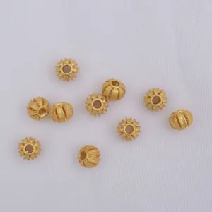 Golden filigree pumpkin spacer beads with detailed texture for DIY jewelry making