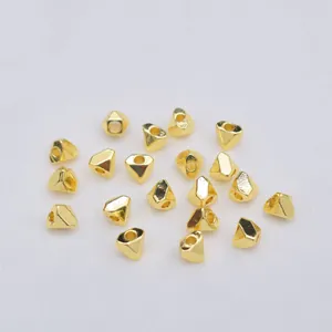 Macro shot of 14K gold-filled geometric faceted spacer beads for DIY jewelry making