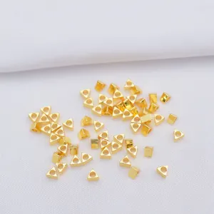 Macro detail of 14k gold-filled triangular spacers for DIY jewelry making and beading