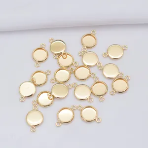 Detail of 14k gold-plated round bezel pendant settings with double loops for DIY jewelry