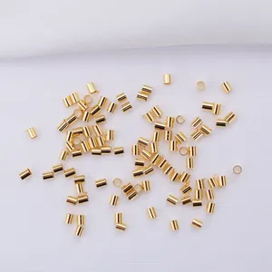 Close-up of 14k gold-filled cylindrical crimp beads for DIY jewelry making and bead crafts
