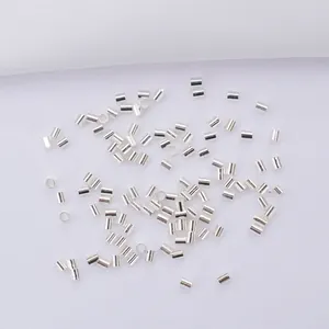 Macro detail of tiny polished silver metal crimp beads for jewelry making projects