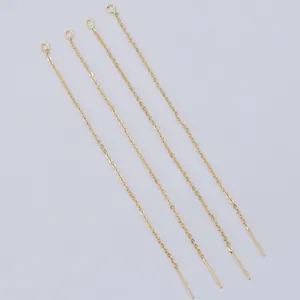 Close-up of 14k gold-filled earring chains with open jump rings and long needle pins