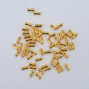 Macro shot of 14K gold filled cylindrical spacer beads with grooved center for DIY jewelry