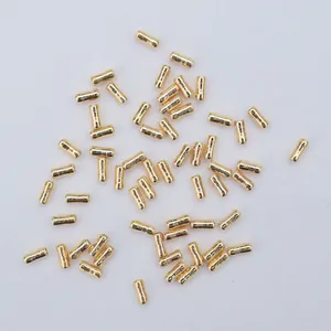 Macro shot of polished gold-plated tubular spacer beads for DIY jewelry making