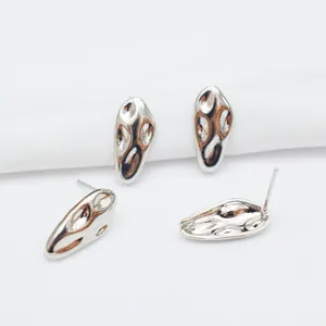 Detailed macro view of S925 silver stud earrings with liquid metal irregular design