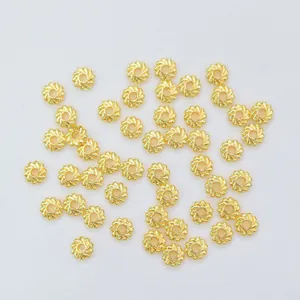 Macro shot of 14K gold-filled hollow round spacer beads with spiral texture for DIY jewelry
