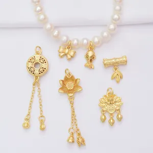 Golden lotus and koi pendants set on a white pearl necklace with vintage matte finish