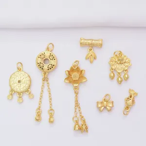 Macro detail of seven gold-plated pendants featuring lotus, bamboo, and koi fish charms