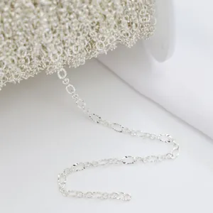 Macro detail of textured oval link chain on spool for handmade DIY jewelry making