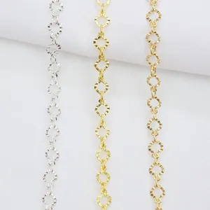 Close-up of 14k gold-filled and silver chains with textured diamond-shaped links for DIY