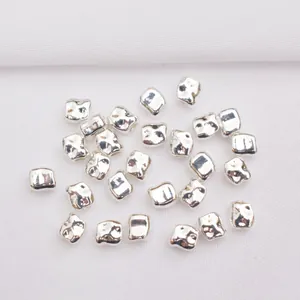 Close-up of 14k gold-plated silver spacer beads with hammer texture for DIY jewelry