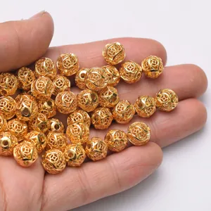 24k gold-plated hollow coin beads for DIY jewelry making featuring intricate filigree design