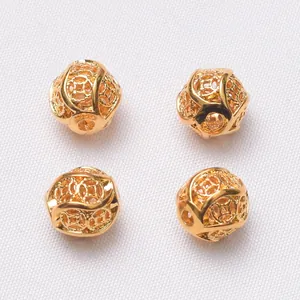 Macro shot of four 24k gold hollow coin-pattern spacer beads for DIY jewelry making