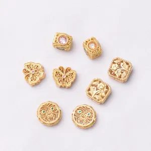 Detailed close-up of gold hollow butterfly and floral beads with colorful zircon stones