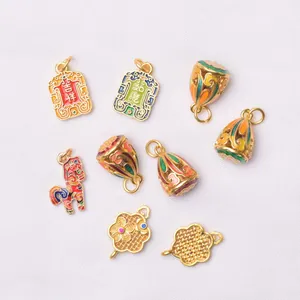 Detailed view of colorful enamel and gold charms with traditional Chinese symbols