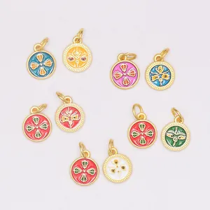 Detail of colorful enamel round gold-plated metal charms for DIY jewelry making