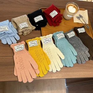Flat lay of knit lace hollow-out fingerless gloves in ten diverse vibrant colors