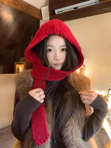 Detail of red chunky knit hooded scarf showing soft texture and warm winter design
