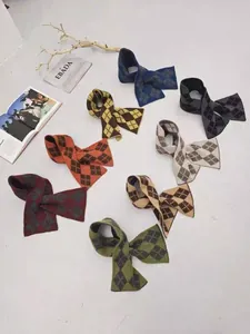 Flat lay of knit wool neck warmers with argyle patterns in eight stylish colors