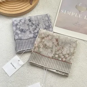 Chic cotton linen square scarves with floral print and wavy borders on plush background