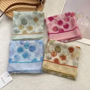 Set of four colorful polka dot cotton linen scarves in pastel green, purple, blue and yellow