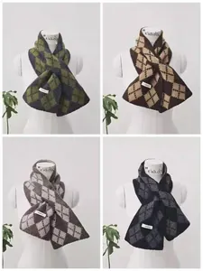 Macro detail of knitted wool scarves featuring geometric diamond patterns and labels