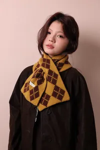 Close-up of a 100% pure wool scarf with yellow and brown jacquard diamond pattern