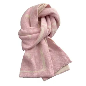 Thick pink and beige geometric knit scarf with a soft cashmere-like texture for winter