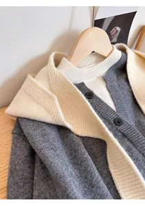 Close-up of gray knit cardigan texture with white scarf collar and round buttons