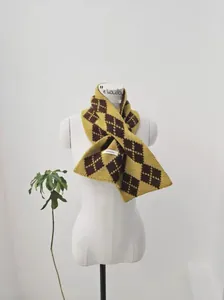 Detailed close-up of argyle knit wool scarf featuring yellow and brown diamond patterns