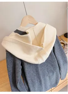 Detail of grey and beige knitted balaclava hood featuring thick texture and premium fiber