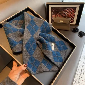 Detail shot of navy and charcoal argyle wool knit scarf with soft diamond pattern
