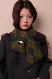 Close-up of pure wool knitted scarf with argyle pattern and wool care label detail