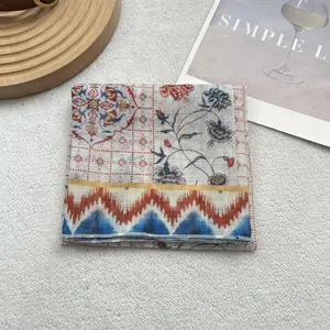 Detail of vintage floral print cotton linen scarf with fine rolled edges and ethnic patterns