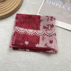 Close-up of floral cotton linen scarf with detailed overlock stitching and lace patterns