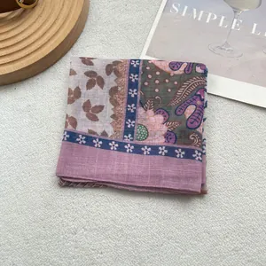 Close-up of lightweight floral cotton linen scarf with soft pink and purple patterns